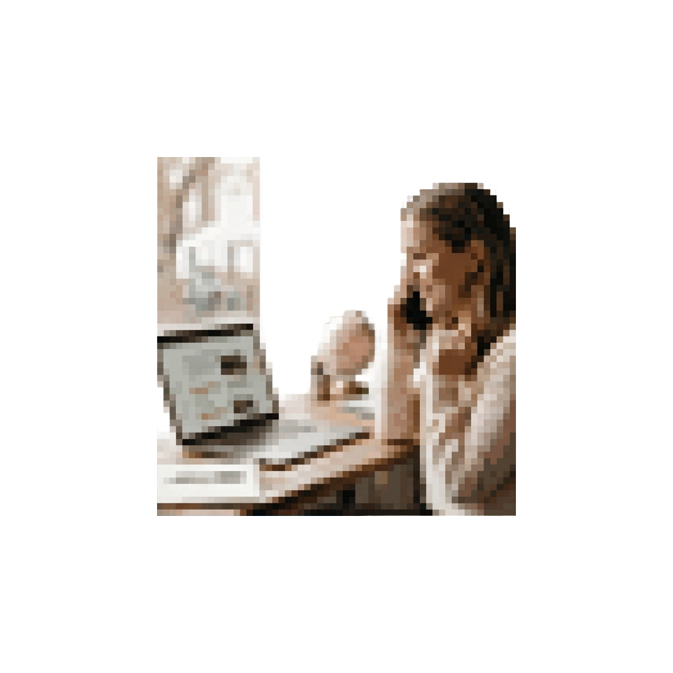A travel advisor reviewing a draft itinerary on a laptop while talking with a client on the phone